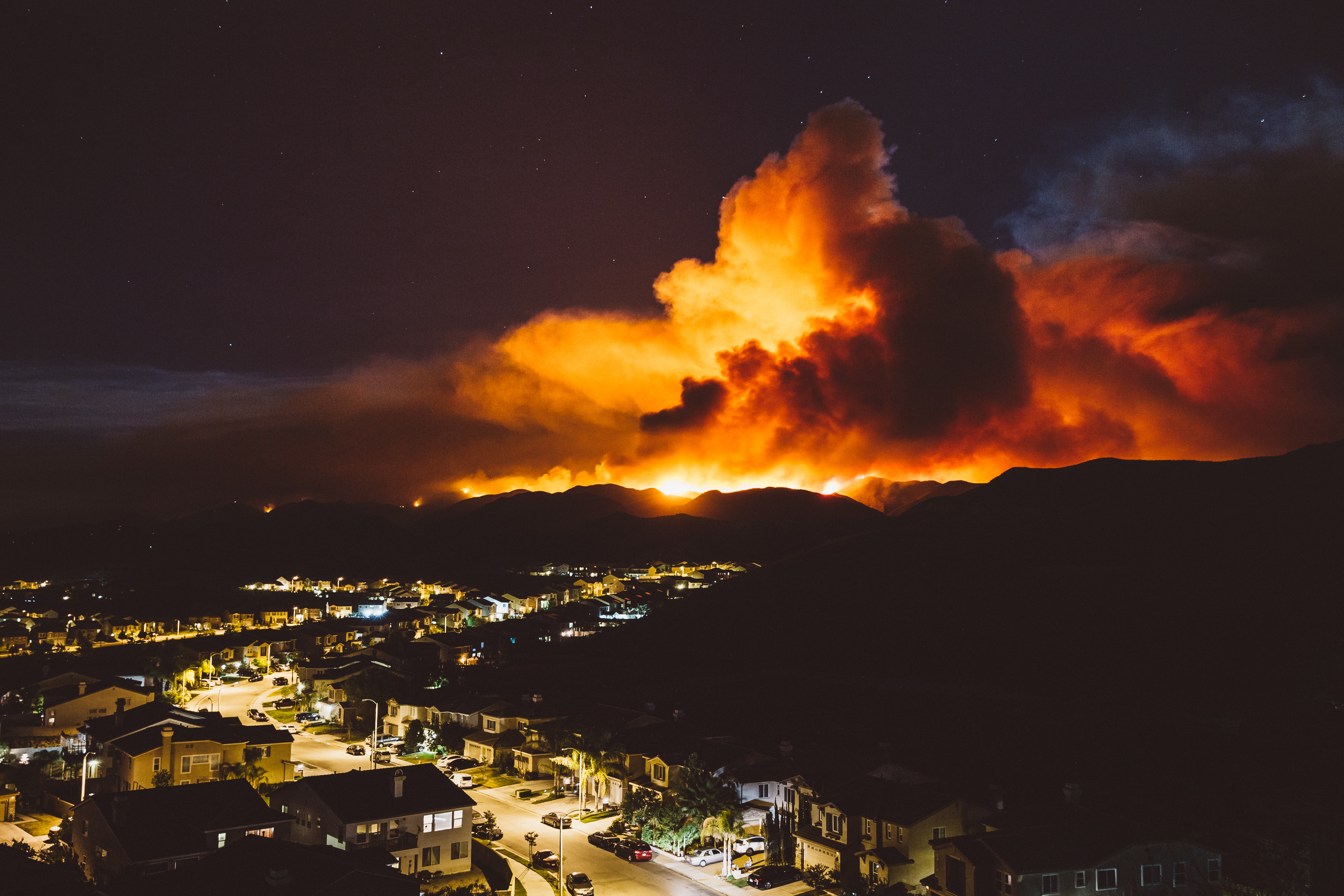 The smoke from Sand brush fire covering Santa Clarita cityscape at sunset in California